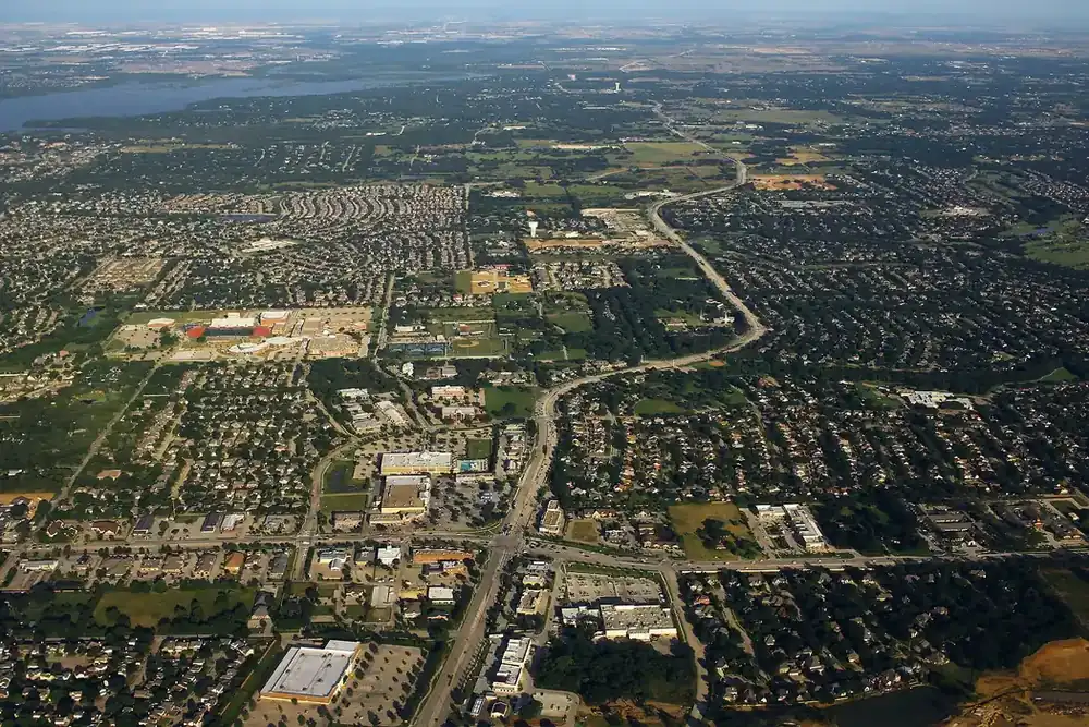 Aerial view of Flower Mound neighborhoods and roads near a lake in Flower Mound, Texas
