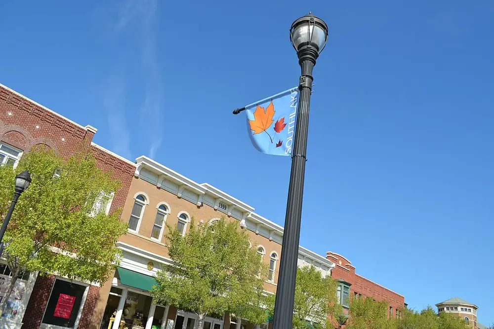 Brick storefront buildings along a street lamp in Southlake Town Square in Southlake, Texas